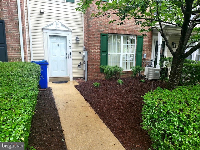 3707 Elmcrest Ln, Bowie, MD 20716 - view of exterior entry featuring central air condition unit and brick siding