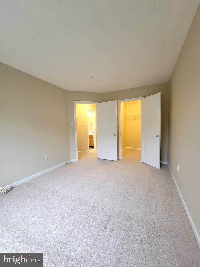 3707 Elmcrest Ln, Bowie, MD 20716 - unfurnished bedroom featuring light carpet, baseboards, a spacious closet, and a closet
