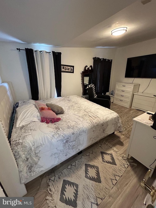 bedroom featuring wood finished floors