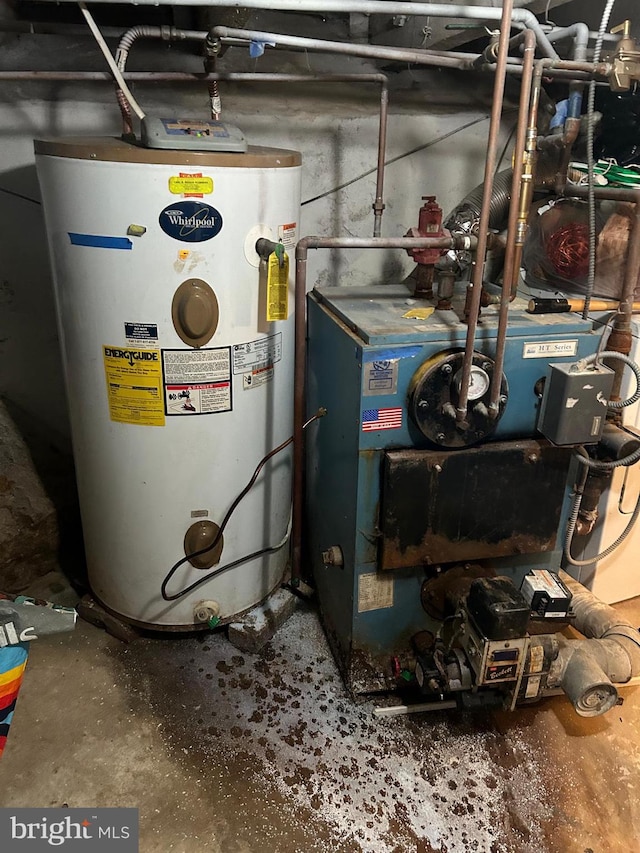 utility room featuring water heater and a heating unit