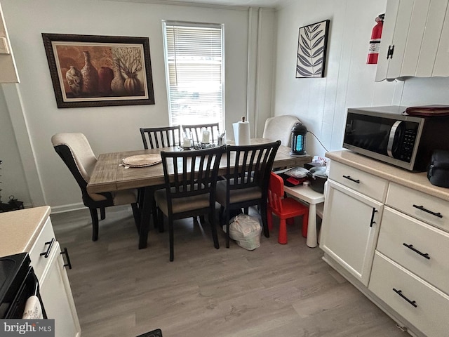 dining space with light wood-type flooring