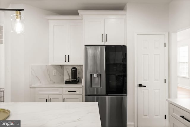902 Santmyer Dr SE, Leesburg, VA 20175 - kitchen with stainless steel fridge, white cabinetry, backsplash, and light stone counters
