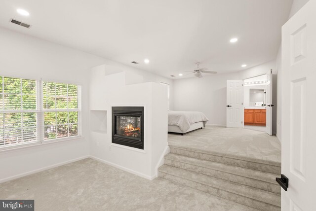902 Santmyer Dr SE, Leesburg, VA 20175 - unfurnished bedroom featuring light colored carpet, recessed lighting, baseboards, a multi sided fireplace, and ensuite bathroom