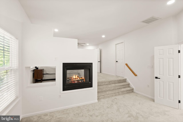 902 Santmyer Dr SE, Leesburg, VA 20175 - unfurnished living room featuring carpet floors, recessed lighting, a multi sided fireplace, baseboards, and stairs