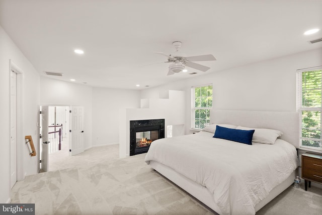 902 Santmyer Dr SE, Leesburg, VA 20175 - bedroom featuring multiple windows, recessed lighting, carpet, a multi sided fireplace, and a ceiling fan