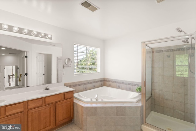 902 Santmyer Dr SE, Leesburg, VA 20175 - full bathroom featuring a bath, a shower stall, double vanity, and tile patterned flooring