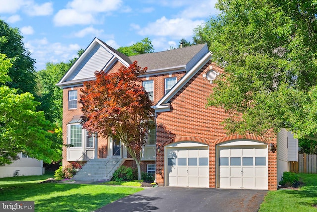 902 Santmyer Dr SE, Leesburg, VA 20175 - view of front facade with driveway, a garage, a front lawn, and brick siding