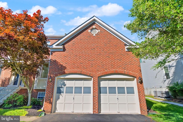 902 Santmyer Dr SE, Leesburg, VA 20175 - view of front facade with brick siding, a garage, and asphalt driveway