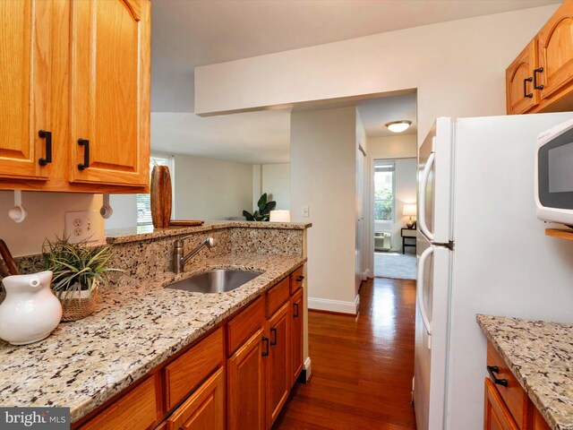 316 Burnside St Unit 101, Annapolis, MD 21403 - kitchen featuring white appliances, plenty of natural light, dark wood-style flooring, and light stone counters