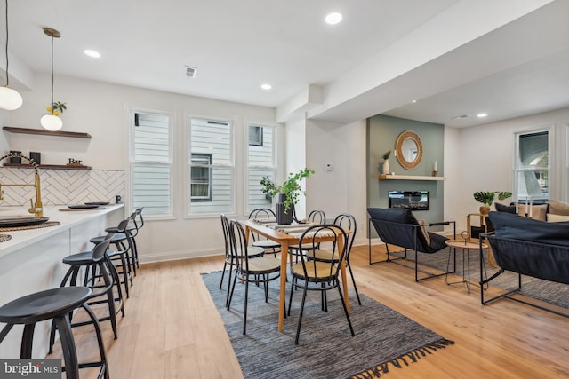 dining area with recessed lighting, baseboards, visible vents, and light wood-style floors