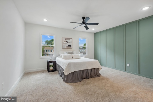 bedroom featuring baseboards, light carpet, and recessed lighting