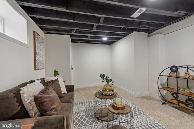 living area featuring carpet floors, baseboards, and visible vents