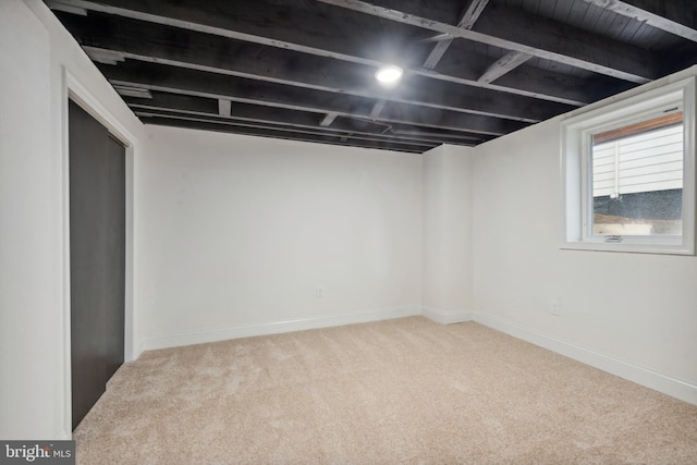 below grade area with carpet flooring and baseboards
