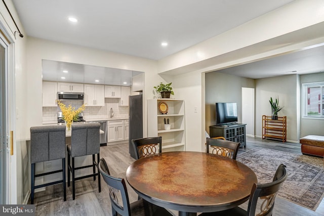 5111 Arrit Ct, Burke, VA 22015 - dining room with light wood-type flooring, recessed lighting, and baseboards
