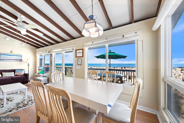 4505-4507 Ocean Blvd, Long Beach Township, NJ 08008 - dining room featuring a water view, wood finished floors, a ceiling fan, and vaulted ceiling with beams