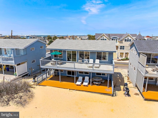 4505-4507 Ocean Blvd, Long Beach Township, NJ 08008 - back of property with a wooden deck, a residential view, and a shingled roof