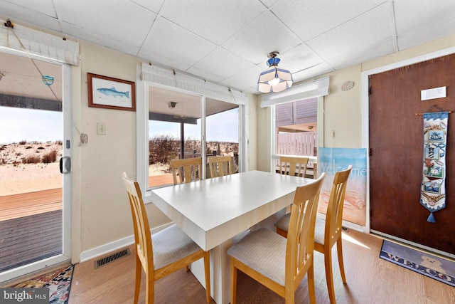4505-4507 Ocean Blvd, Long Beach Township, NJ 08008 - dining space with baseboards, a drop ceiling, visible vents, and wood finished floors