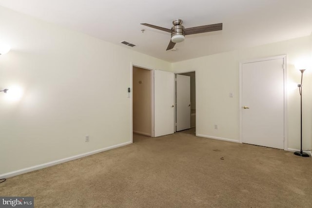 unfurnished bedroom with visible vents, baseboards, ceiling fan, and light carpet