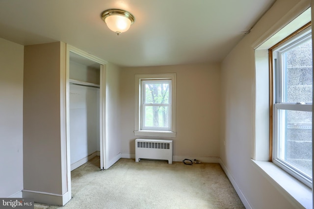 501 Walker Hill Rd, Newport, PA 17074 - unfurnished bedroom featuring radiator heating unit, light carpet, baseboards, and a closet