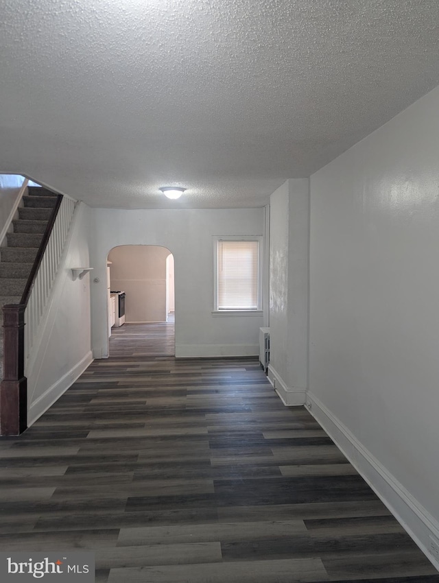 426 Royden St, Camden, NJ 08103 - interior space with arched walkways, a textured ceiling, stairs, baseboards, and wood finished floors
