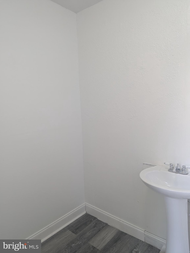 426 Royden St, Camden, NJ 08103 - bathroom featuring baseboards, a sink, and wood finished floors