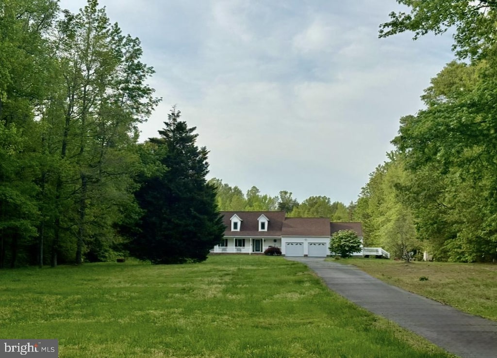 view of front of home with an attached garage, driveway, and a front yard