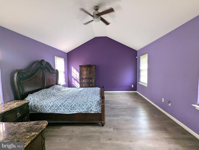 bedroom featuring vaulted ceiling, wood finished floors, baseboards, and ceiling fan