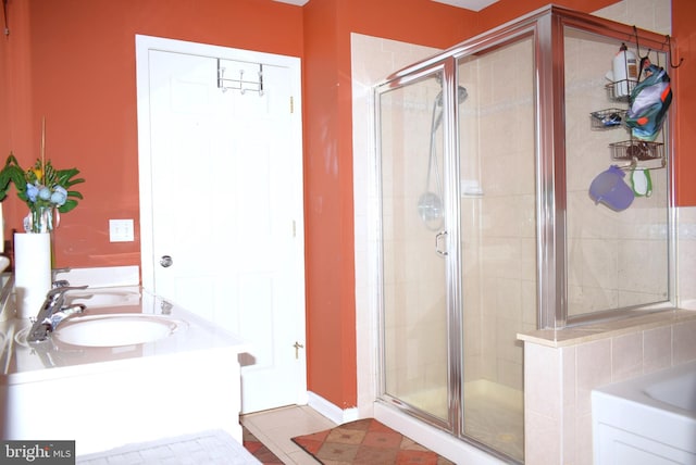 full bath featuring a stall shower, a sink, a bath, and tile patterned flooring