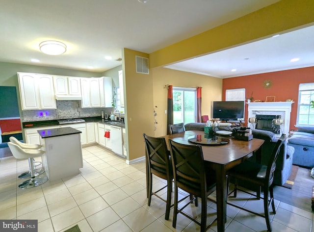 kitchen featuring stainless steel gas cooktop, dark countertops, plenty of natural light, open floor plan, and recessed lighting
