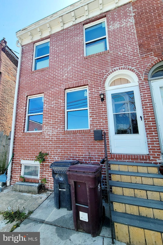 exterior space with brick siding and entry steps