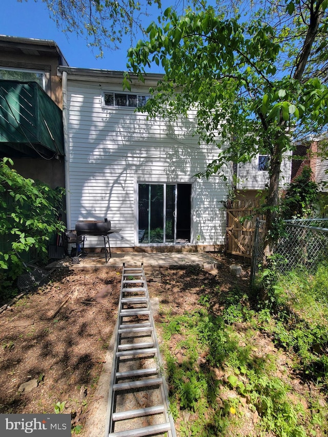 rear view of property with fence