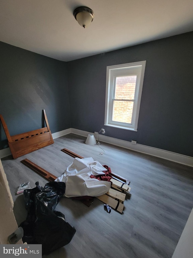 interior space featuring baseboards and wood finished floors