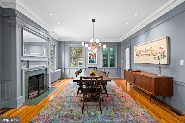 3101 Highland Pl NW, Washington, DC 20008 - dining area with an inviting chandelier, crown molding, a decorative wall, and wood finished floors