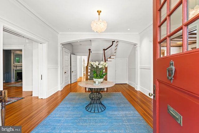 3101 Highland Pl NW, Washington, DC 20008 - foyer with stairs, arched walkways, an inviting chandelier, and wood finished floors