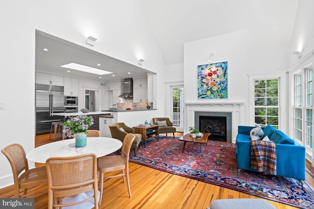 3101 Highland Pl NW, Washington, DC 20008 - dining room with a healthy amount of sunlight, recessed lighting, light wood-type flooring, and a fireplace with flush hearth