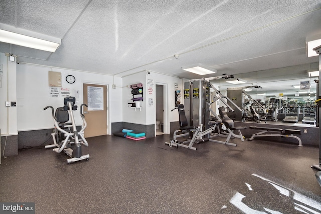 exercise room featuring a textured ceiling