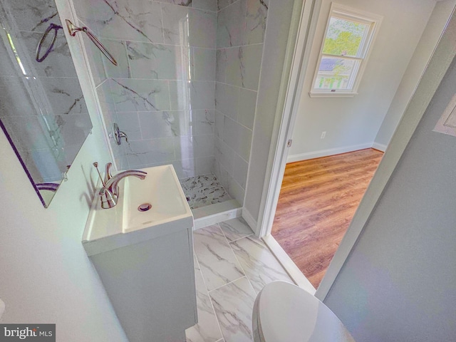 full bathroom featuring a stall shower, vanity, baseboards, toilet, and marble finish floor
