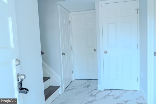 hallway with marble finish floor