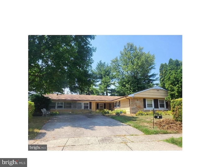 single story home with concrete driveway