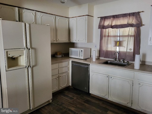 kitchen featuring dark wood-style flooring, white appliances, light countertops, white cabinets, and a sink