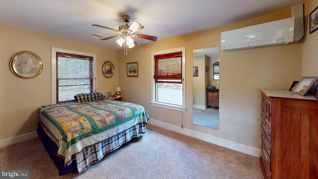 carpeted bedroom with multiple windows, visible vents, baseboards, and an AC wall unit