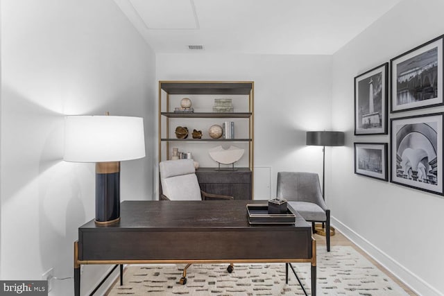 office area featuring baseboards, wood finished floors, and visible vents