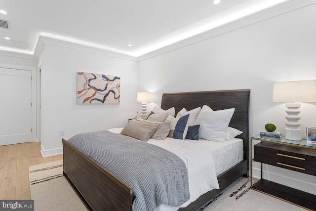 bedroom with visible vents, baseboards, wood-type flooring, ornamental molding, and recessed lighting