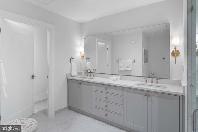 bathroom with a sink, tile patterned floors, a stall shower, and double vanity