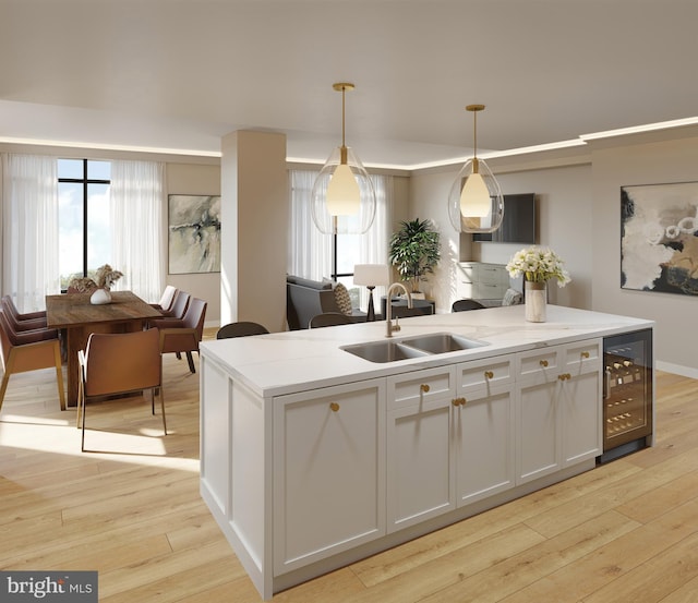 kitchen with a kitchen island, hanging light fixtures, light wood-type flooring, a sink, and beverage cooler