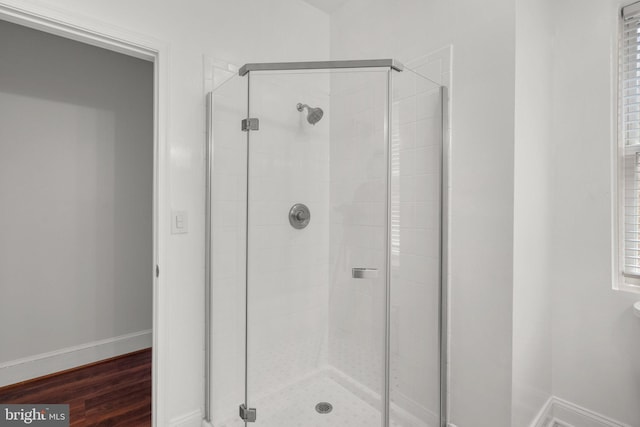66 O St NW, Washington, DC 20001 - full bath featuring baseboards, a stall shower, and wood finished floors