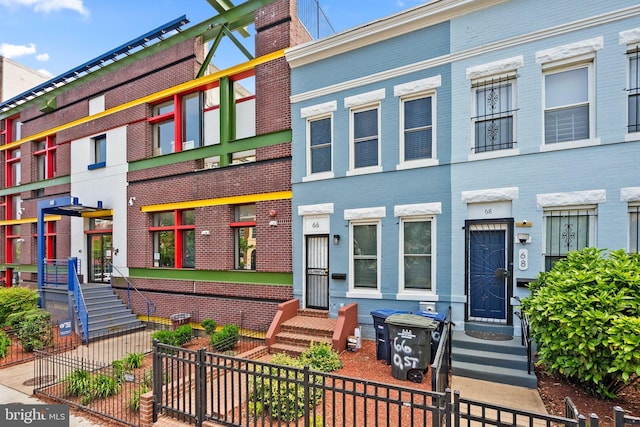 66 O St NW, Washington, DC 20001 - townhome / multi-family property featuring brick siding and a fenced front yard