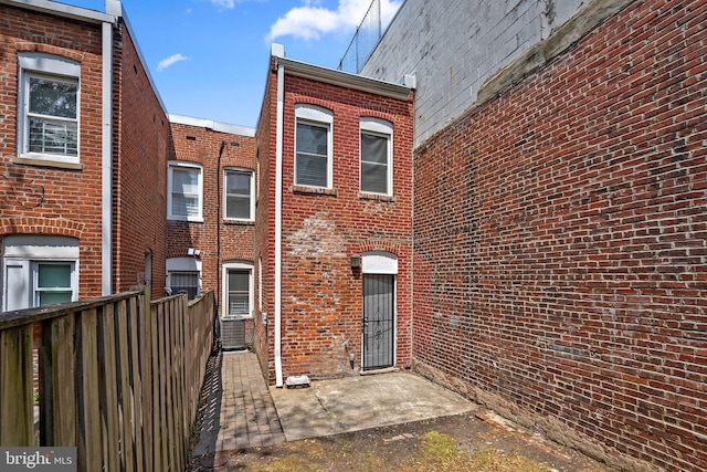 66 O St NW, Washington, DC 20001 - back of property featuring brick siding, fence, and central air condition unit