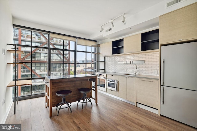 2030 8th St NW Unit Ph-5, Washington, DC 20001 - kitchen featuring high end fridge, a sink, stainless steel oven, open shelves, and backsplash