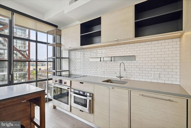 2030 8th St NW Unit Ph-5, Washington, DC 20001 - kitchen with open shelves, stainless steel oven, a sink, and decorative backsplash